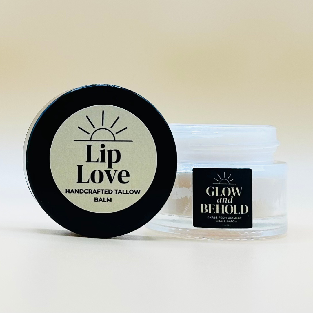 Lip balm container labeled 'Lip Love' and a jar labeled 'Glow and Behold' on a light background